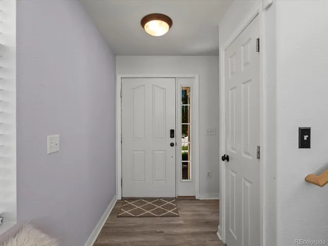an empty room with wooden floor and mirror