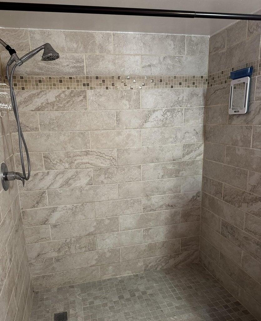 3615 Northwest Adriatic Lane, Unit 204 Jensen Beach, FL 34957 - Photo 17 of 40 a bathroom with a shower