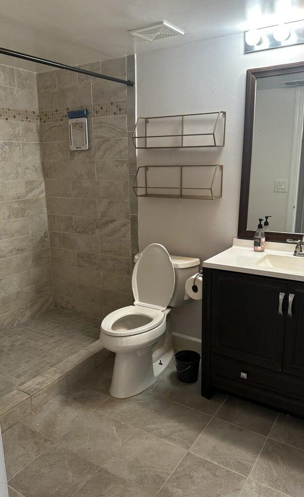 3615 Northwest Adriatic Lane, Unit 204 Jensen Beach, FL 34957 - Photo 18 of 40 a bathroom with a toilet sink and shower