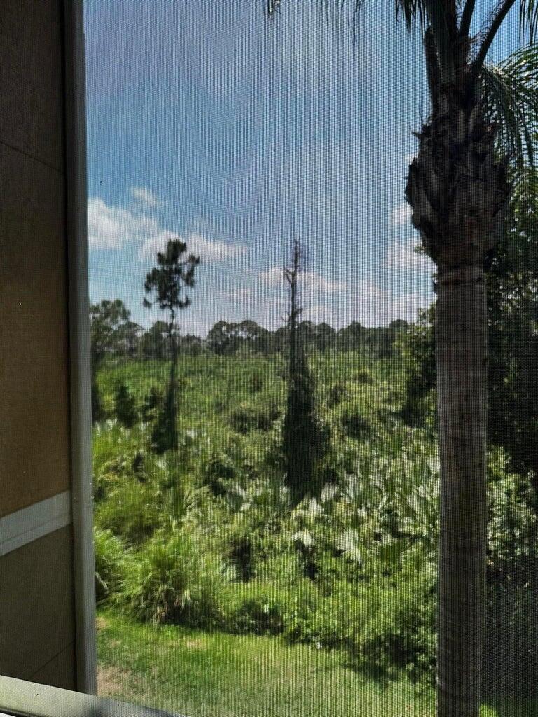 3615 Northwest Adriatic Lane, Unit 204 Jensen Beach, FL 34957 - Photo 2 of 40 a view of a garden