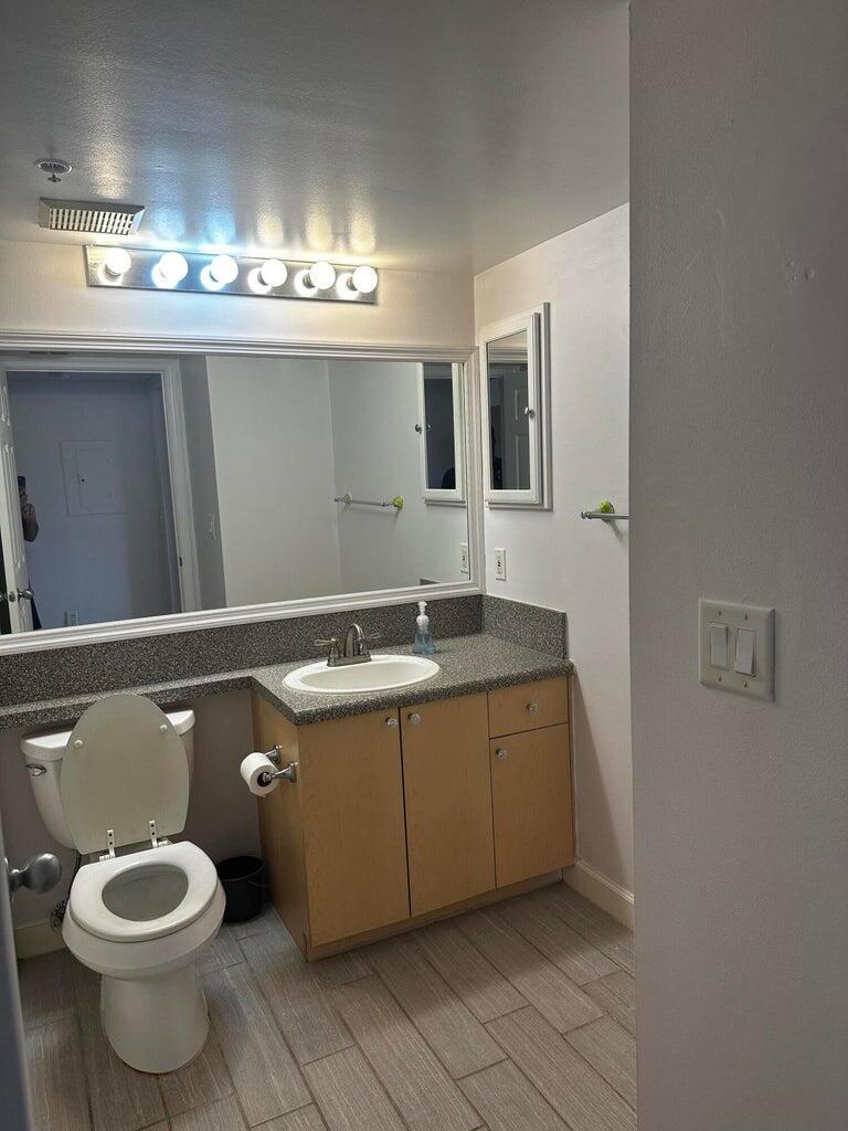 3615 Northwest Adriatic Lane, Unit 204 Jensen Beach, FL 34957 - Photo 22 of 40 a bathroom with a sink and a mirror