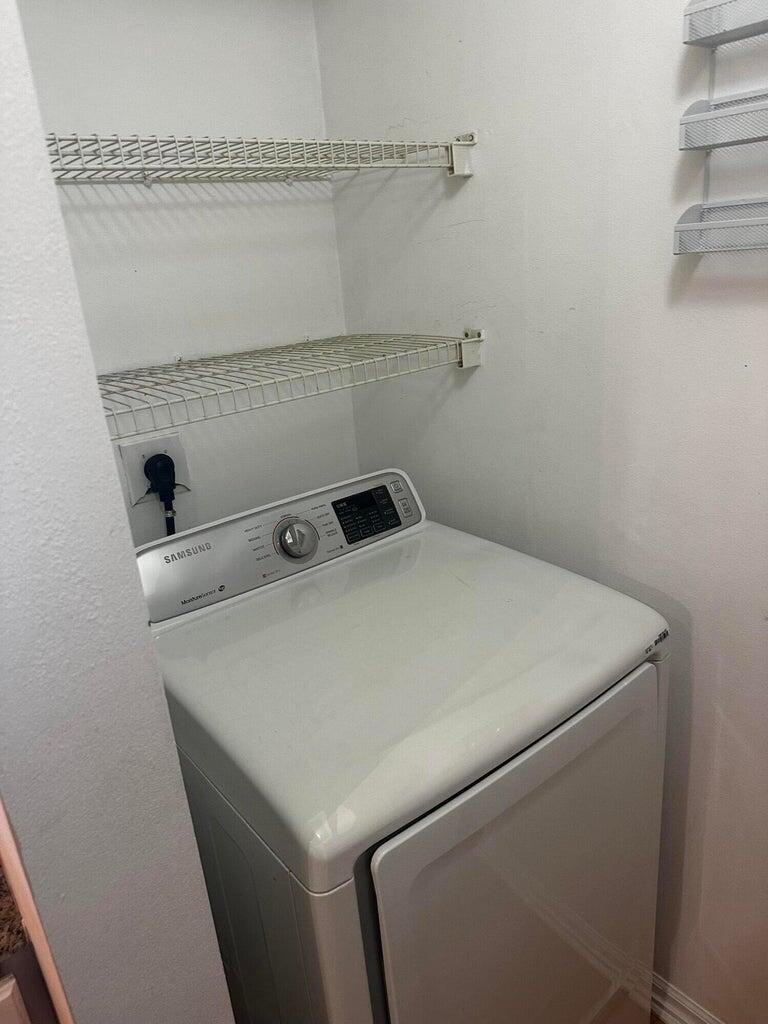 3615 Northwest Adriatic Lane, Unit 204 Jensen Beach, FL 34957 - Photo 23 of 40 a utility room with dryer and washer