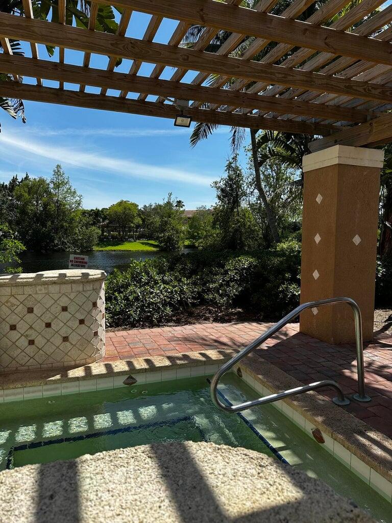 3615 Northwest Adriatic Lane, Unit 204 Jensen Beach, FL 34957 - Photo 25 of 40 a backyard of a house with lots of green space