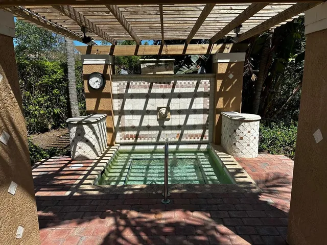 a view of a swimming pool with a garden and trees