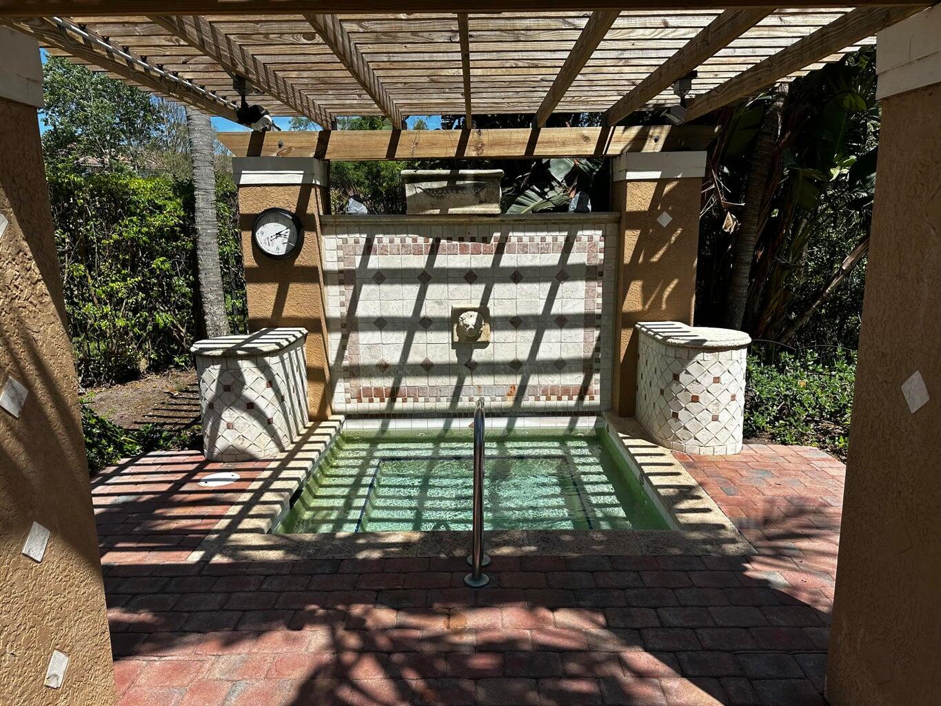 3615 Northwest Adriatic Lane, Unit 204 Jensen Beach, FL 34957 - Photo 26 of 40 a view of a backyard with sitting area