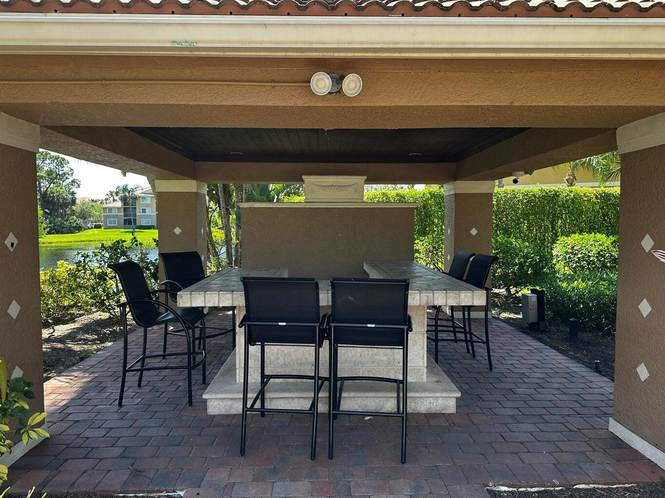 3615 Northwest Adriatic Lane, Unit 204 Jensen Beach, FL 34957 - Photo 28 of 40 a view of an outdoor seating area