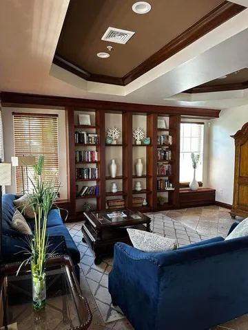 a view of a workspace with furniture and a potted plant