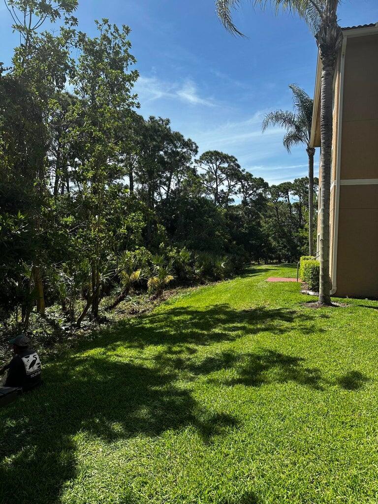 3615 Northwest Adriatic Lane, Unit 204 Jensen Beach, FL 34957 - Photo 6 of 40 a view of a field with a tree in the background
