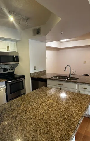 a kitchen with sink and a stove top oven