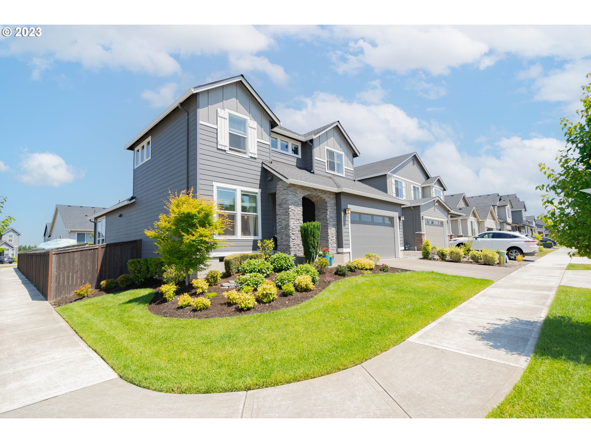 8518 North 1st Street Ridgefield, WA 98642 - Photo 1 of 41 a front view of a house with a garden and patio