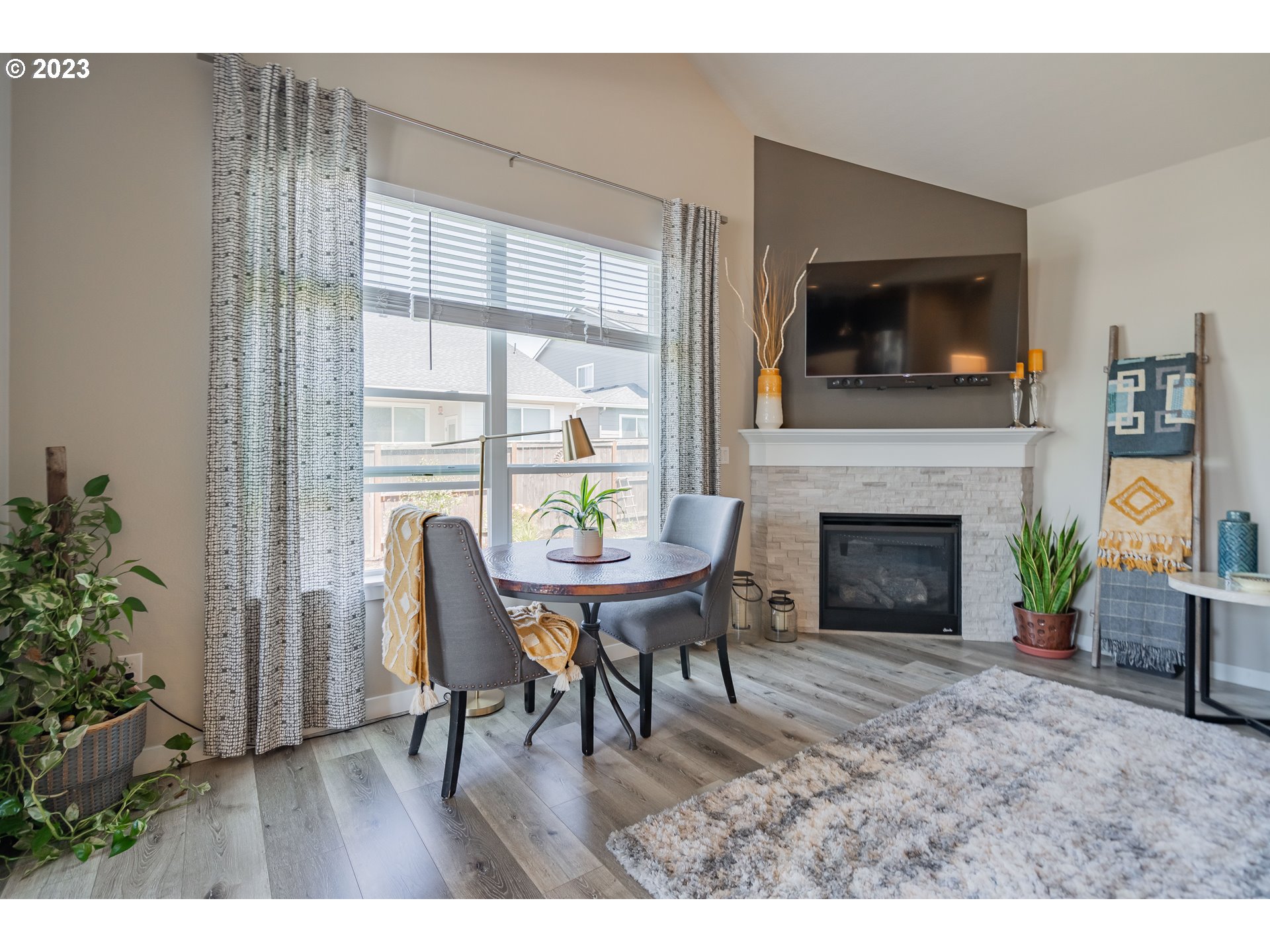 8518 North 1st Street Ridgefield, WA 98642 - Photo 15 of 41 a living room with furniture a flat screen tv and a fireplace