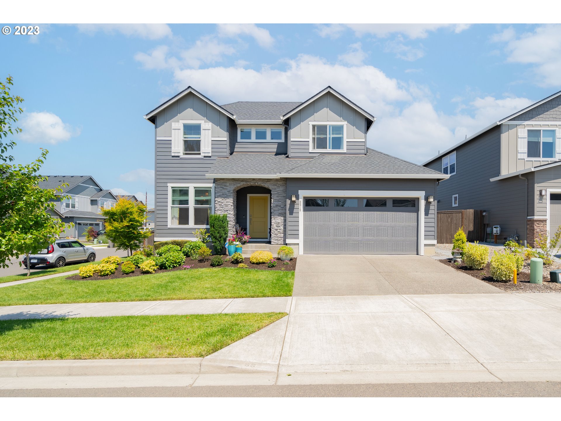 8518 North 1st Street Ridgefield, WA 98642 - Photo 2 of 41 a front view of a house with a garden and plants