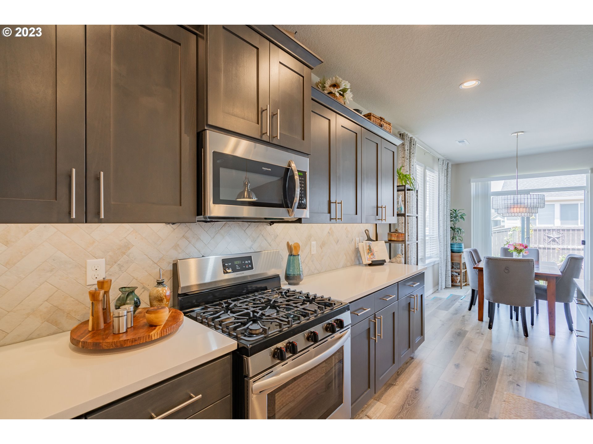 8518 North 1st Street Ridgefield, WA 98642 - Photo 5 of 41 a kitchen with stainless steel appliances granite countertop a stove top oven a sink dishwasher and cabinets with wooden floor