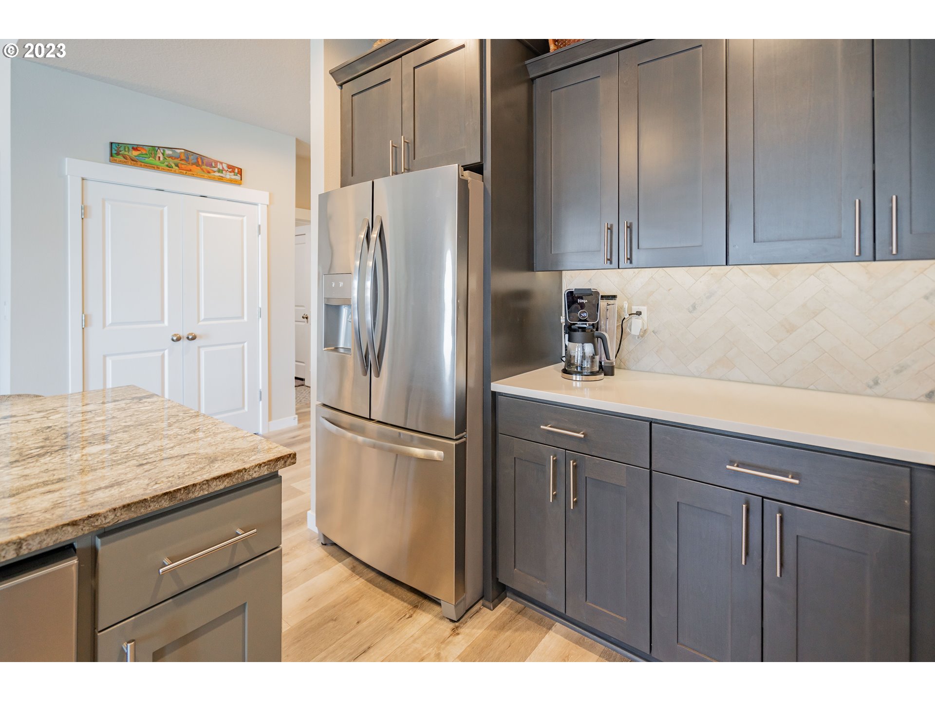 8518 North 1st Street Ridgefield, WA 98642 - Photo 7 of 41 a kitchen with a refrigerator and cabinets