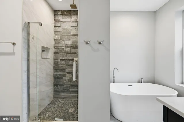 a bathroom with a bathtub and shower