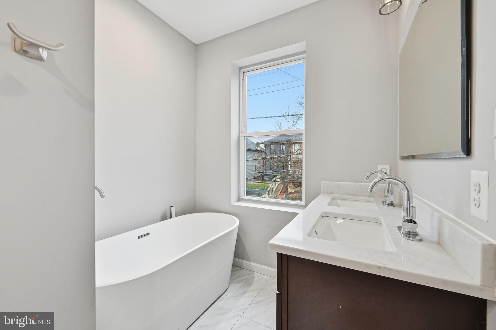 824 Allison Street Northwest Washington, DC 20011 - Photo 17 of 26 a bathroom with a sink and a bathtub