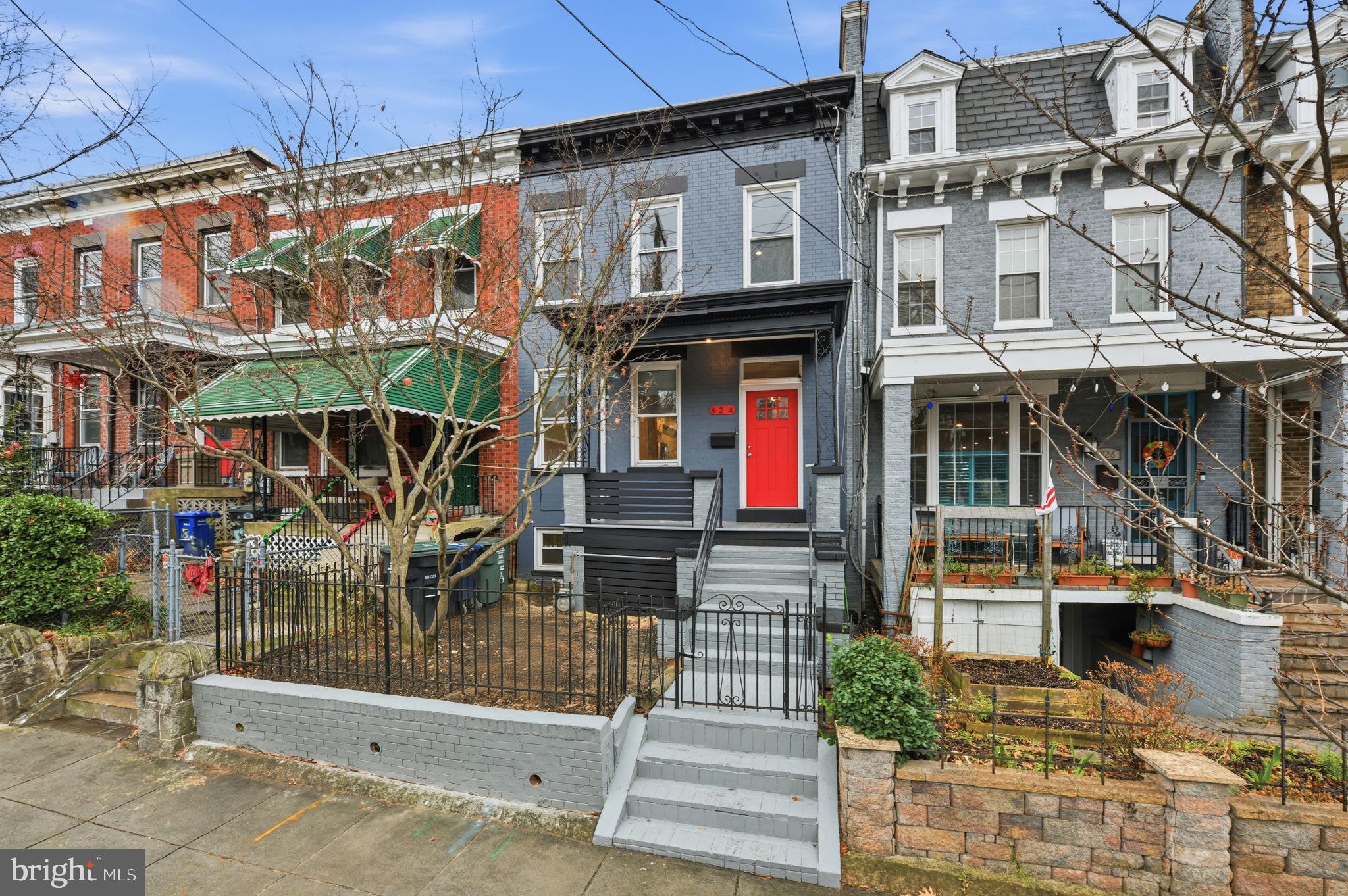 824 Allison Street Northwest Washington, DC 20011 - Photo 22 of 26 a front view of a building with glass windows and a table
