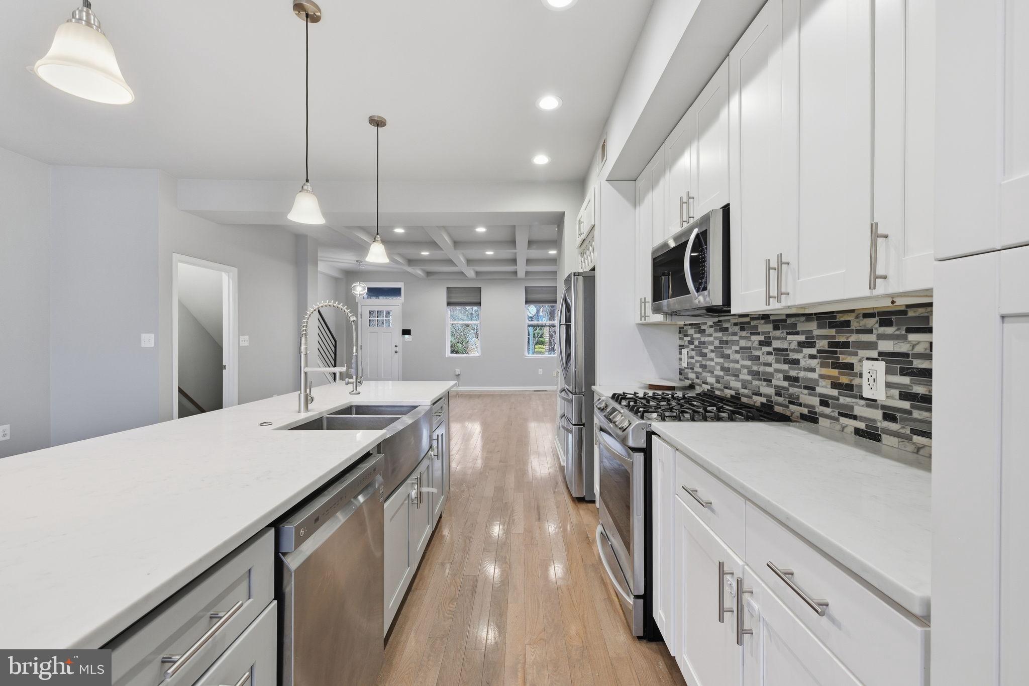 824 Allison Street Northwest Washington, DC 20011 - Photo 5 of 26 a kitchen with a sink stove and white cabinets
