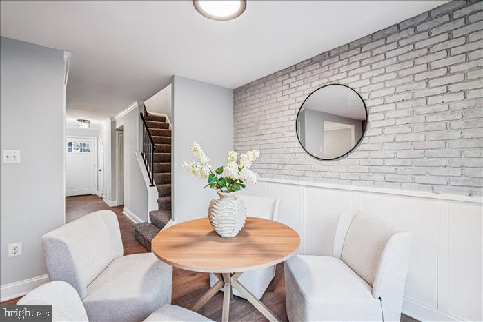 7646 South Arbory Lane, Unit 320 Laurel, MD 20707 - Photo 12 of 45 a living room with furniture a potted plant and a large window