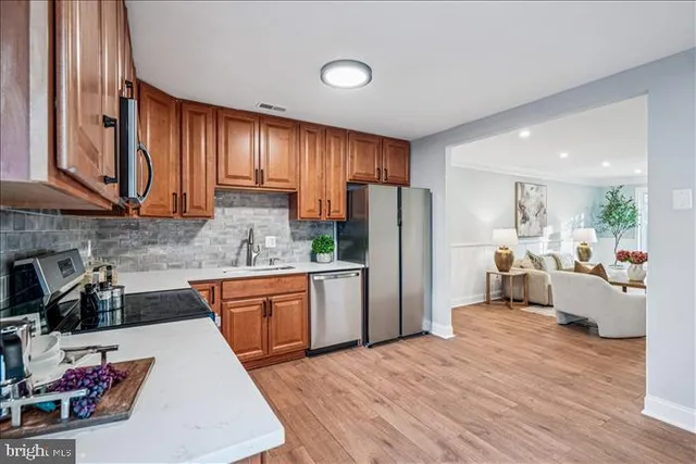 a kitchen with stainless steel appliances granite countertop a refrigerator stove microwave and sink