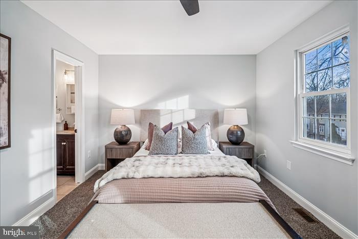 7646 South Arbory Lane, Unit 320 Laurel, MD 20707 - Photo 29 of 45 a large bed sitting in a bedroom next to a window