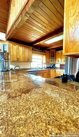 a kitchen with stainless steel appliances granite countertop a sink and cabinets