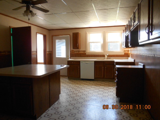 109 West Cleveland Street Spring Valley, IL 61362 - Photo 2 of 11 a kitchen with kitchen island granite countertop a sink cabinets and stainless steel appliances