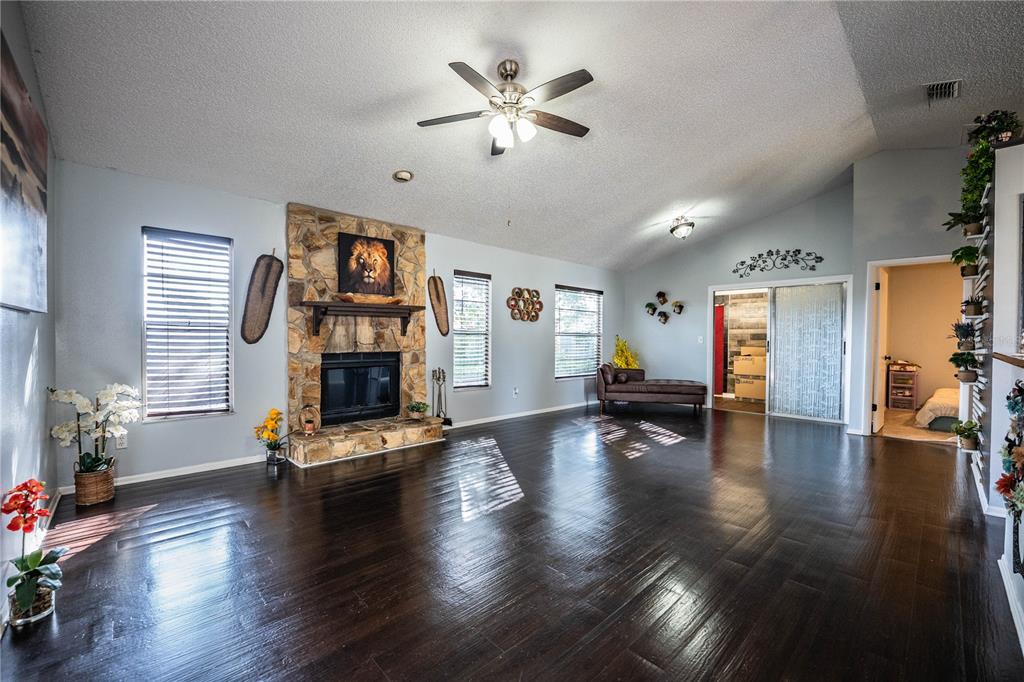 3304 Fox Ridge Drive Winter Haven, FL 33884 - Photo 11 of 60 a living room with fireplace furniture and a wooden floor