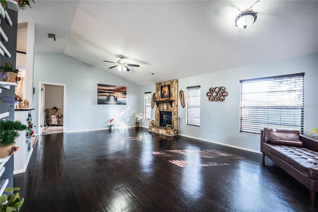 3304 Fox Ridge Drive Winter Haven, FL 33884 - Photo 12 of 60 a view of a livingroom with furniture hardwood floor and a ceiling fan