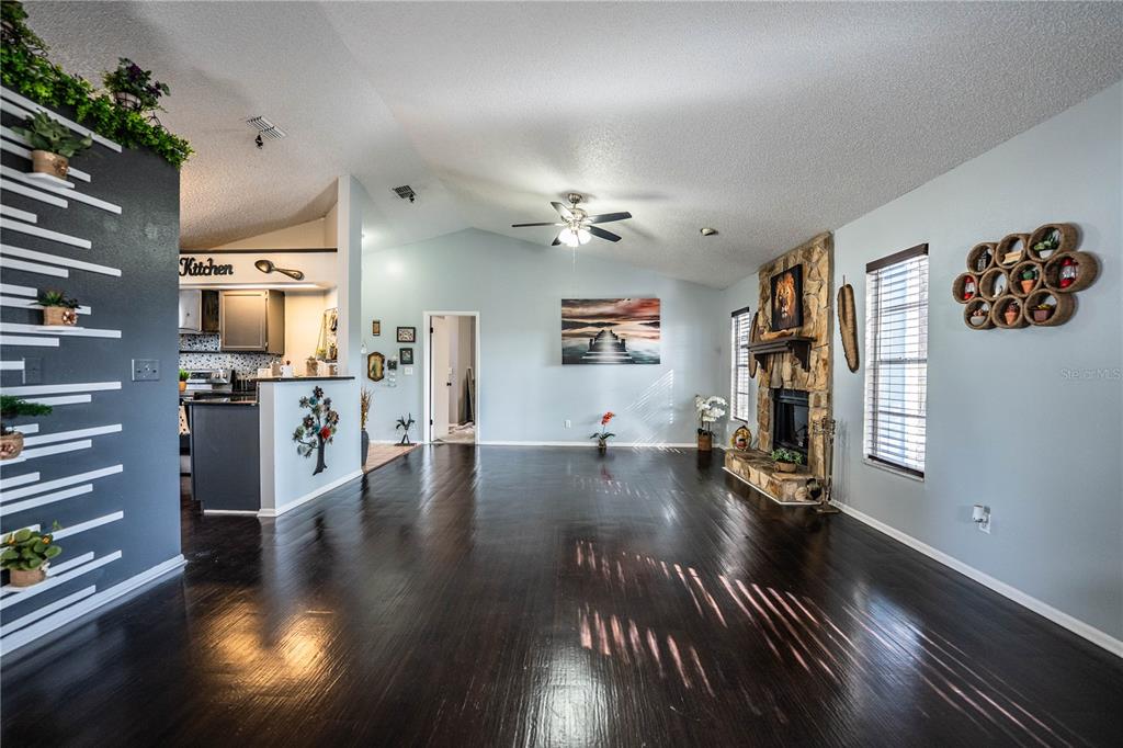 3304 Fox Ridge Drive Winter Haven, FL 33884 - Photo 13 of 60 a view of a living room and kitchen with furniture wooden floor