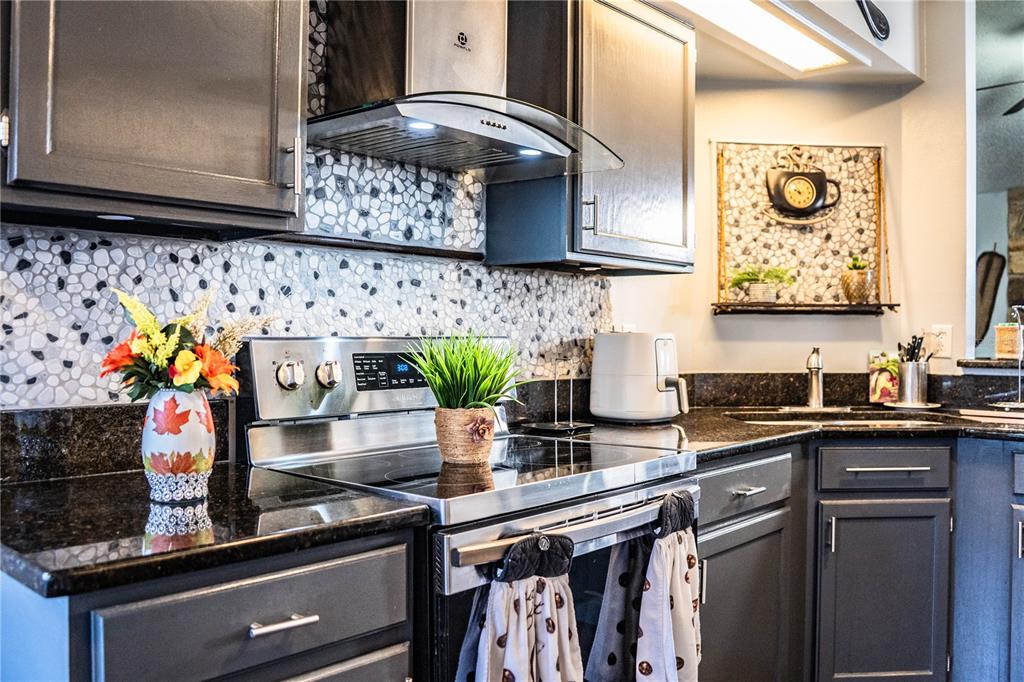 3304 Fox Ridge Drive Winter Haven, FL 33884 - Photo 17 of 60 a kitchen with stainless steel appliances granite countertop a sink and a stove