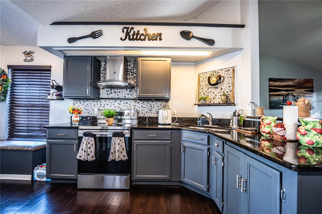 3304 Fox Ridge Drive Winter Haven, FL 33884 - Photo 22 of 60 a kitchen with stainless steel appliances granite countertop a sink and cabinets
