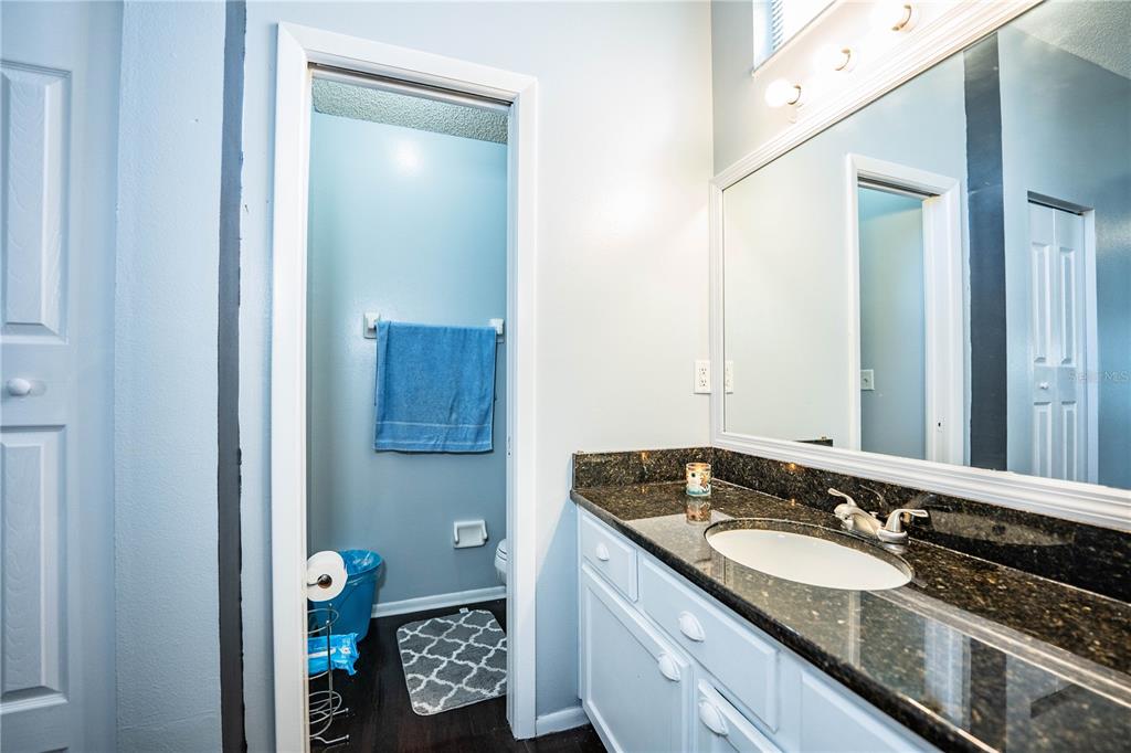 3304 Fox Ridge Drive Winter Haven, FL 33884 - Photo 31 of 60 a bathroom with a granite countertop sink and a mirror