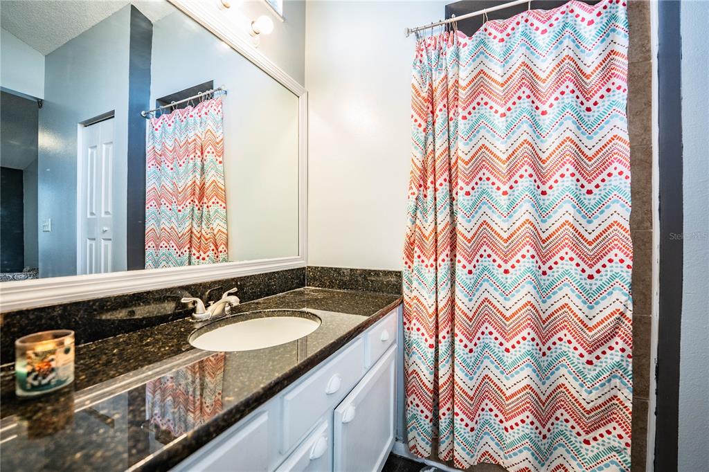 3304 Fox Ridge Drive Winter Haven, FL 33884 - Photo 33 of 60 a bathroom with a sink and a mirror