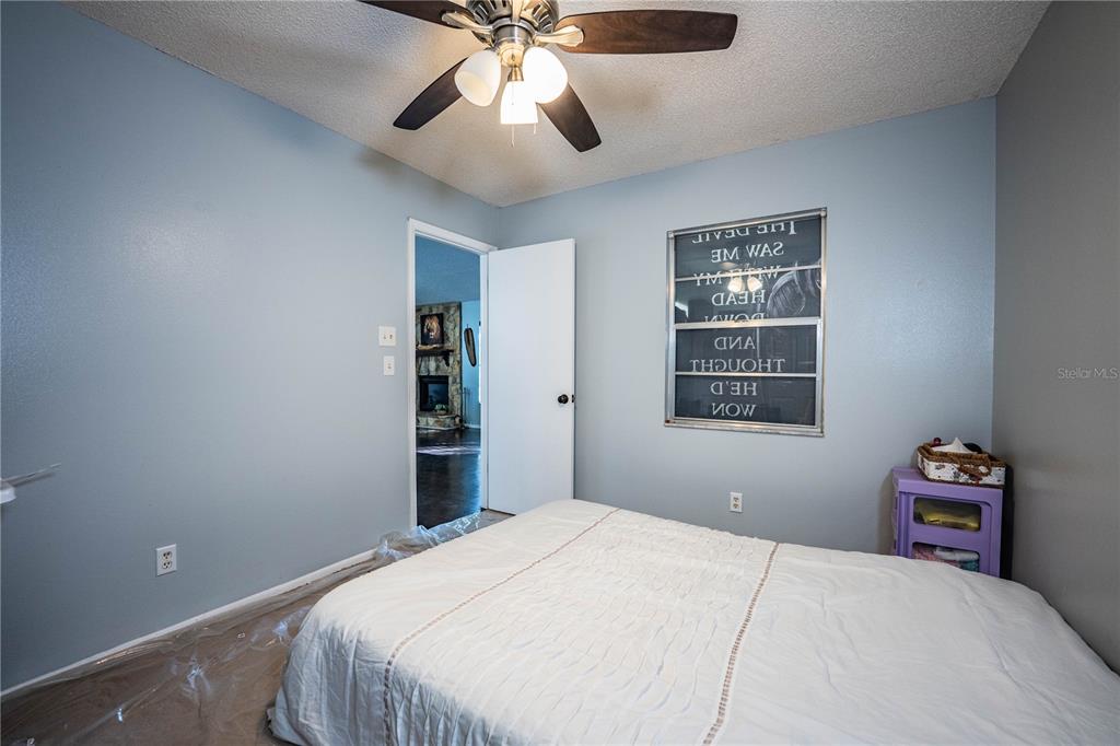 3304 Fox Ridge Drive Winter Haven, FL 33884 - Photo 34 of 60 a bedroom with a large bed and a chandelier