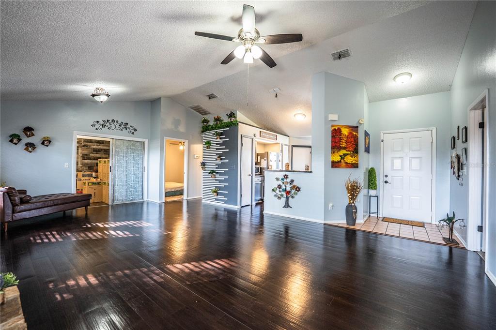 3304 Fox Ridge Drive Winter Haven, FL 33884 - Photo 4 of 60 a view of a livingroom with hardwood floor and a ceiling fan