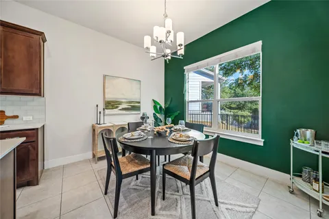 a large living room with stainless steel appliances granite countertop a couch a table and chairs