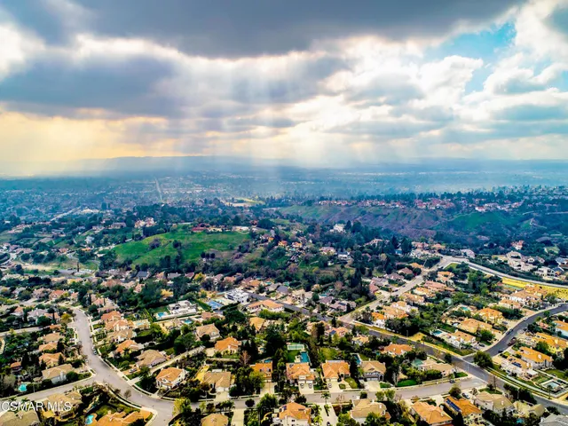 an aerial view of residential building with green space