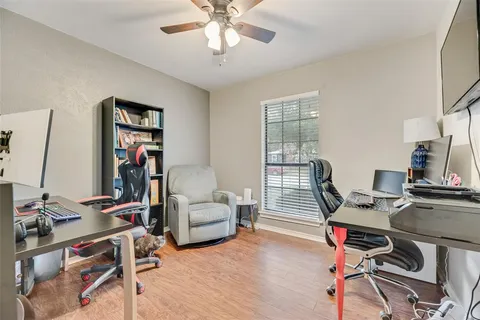 a view of a workspace with furniture and a window