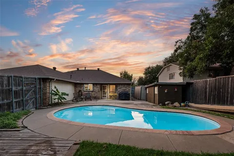 a view of a house with swimming pool and furniture