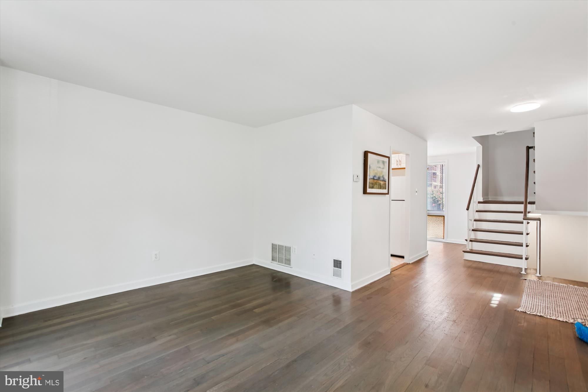 301 I Street Southwest, Unit 108 Washington, DC 20024 - Photo 12 of 55 a view of a livingroom with wooden floor and white walls