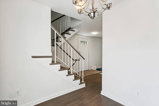 a view of a room with wooden floor and windows