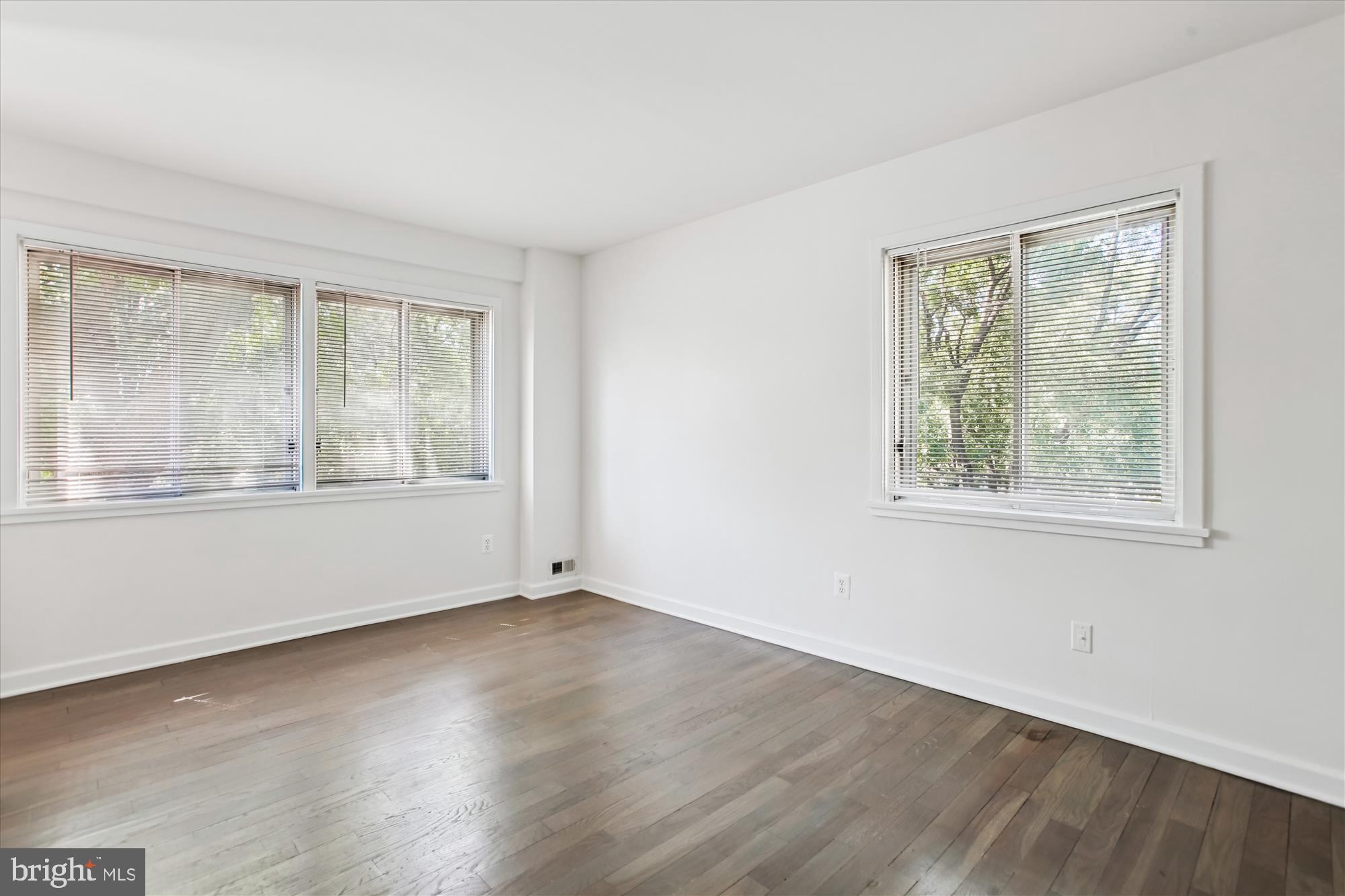 301 I Street Southwest, Unit 108 Washington, DC 20024 - Photo 20 of 55 an empty room with wooden floor and windows