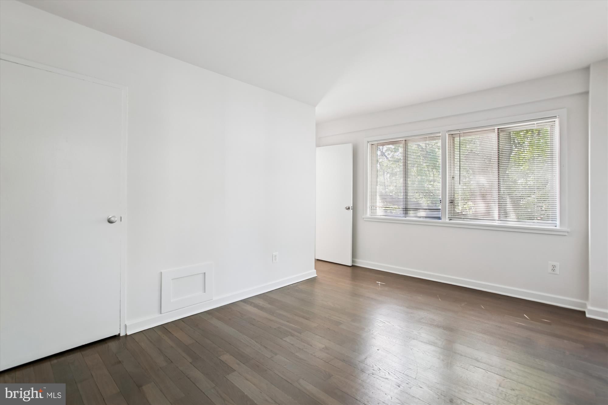 301 I Street Southwest, Unit 108 Washington, DC 20024 - Photo 21 of 55 an empty room with wooden floor and windows