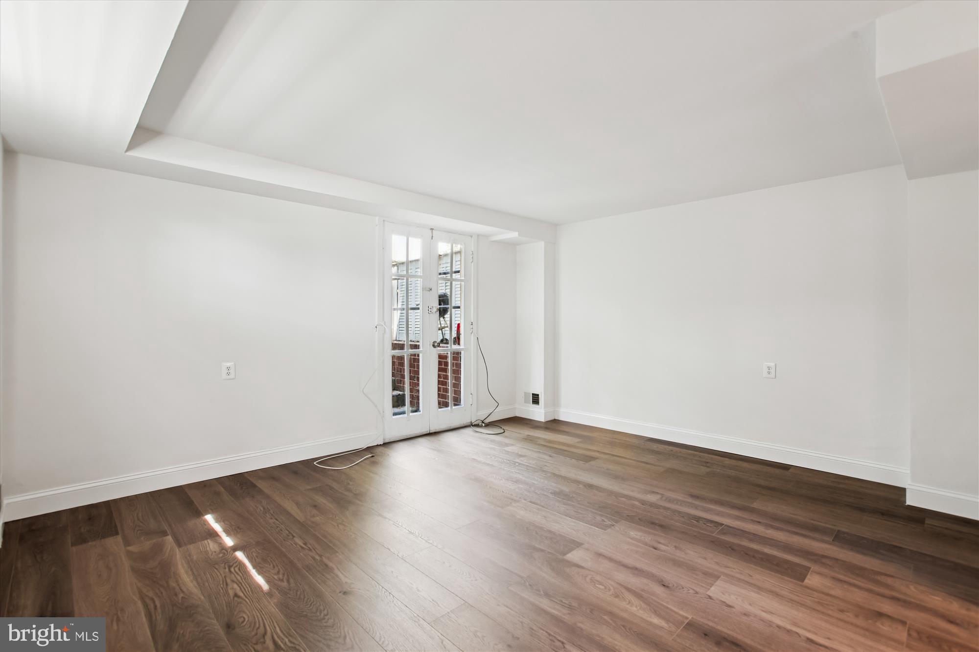 301 I Street Southwest, Unit 108 Washington, DC 20024 - Photo 29 of 55 a view of an empty room with wooden floor and a window