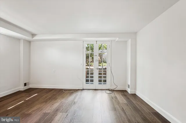 a view of a house with a small space and wooden deck