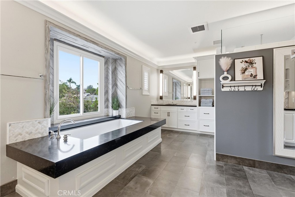 29131 Bouquet Canyon Road Silverado, CA 92676 - Photo 51 of 74 large primary suitr with dual seperate vanaties, large soaker tub, walk in shower, and vanity area.