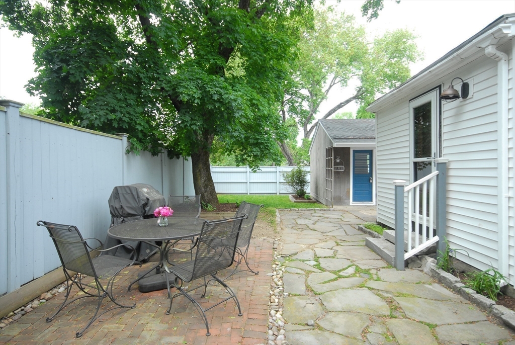 1832 Main Street Concord, MA 01742 - Photo 11 of 25 a view of a tables and chairs in back yard of the house
