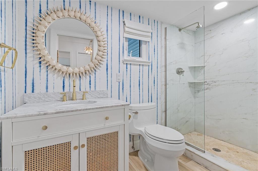 725 2nd Street South Naples, FL 34102 - Photo 16 of 21 a bathroom with a toilet a sink and shower