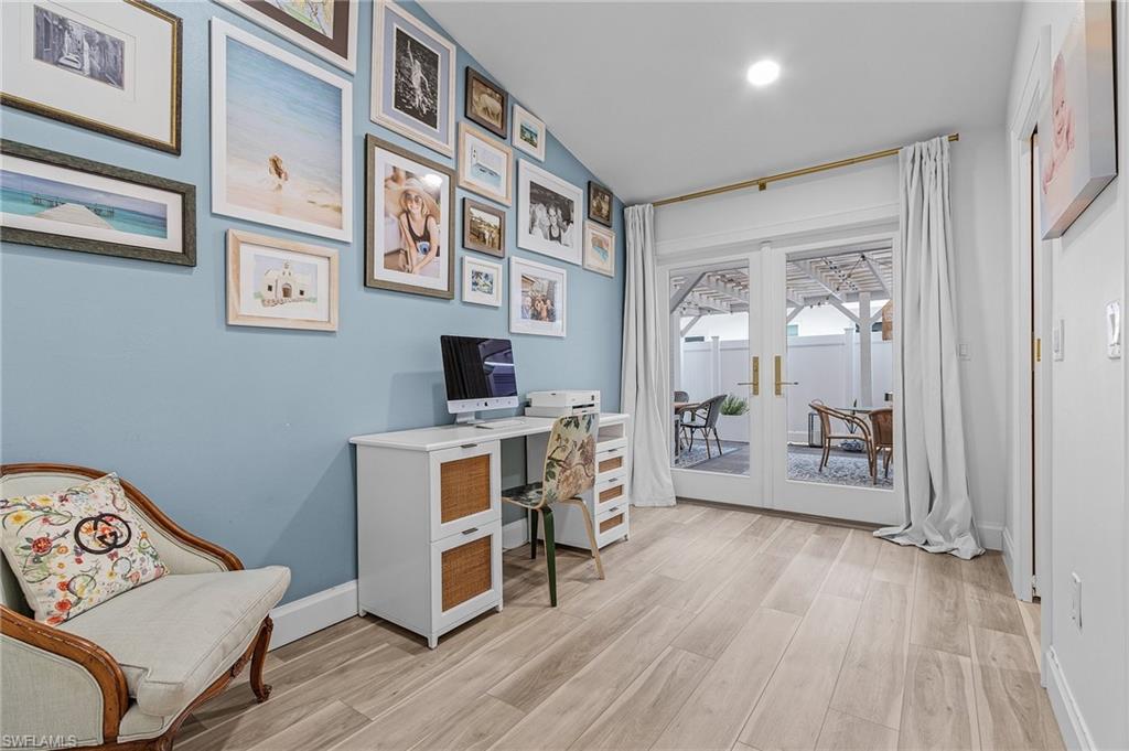 725 2nd Street South Naples, FL 34102 - Photo 17 of 21 a room with furniture a wooden floor and a window